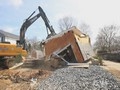 Home being demolished by a crane